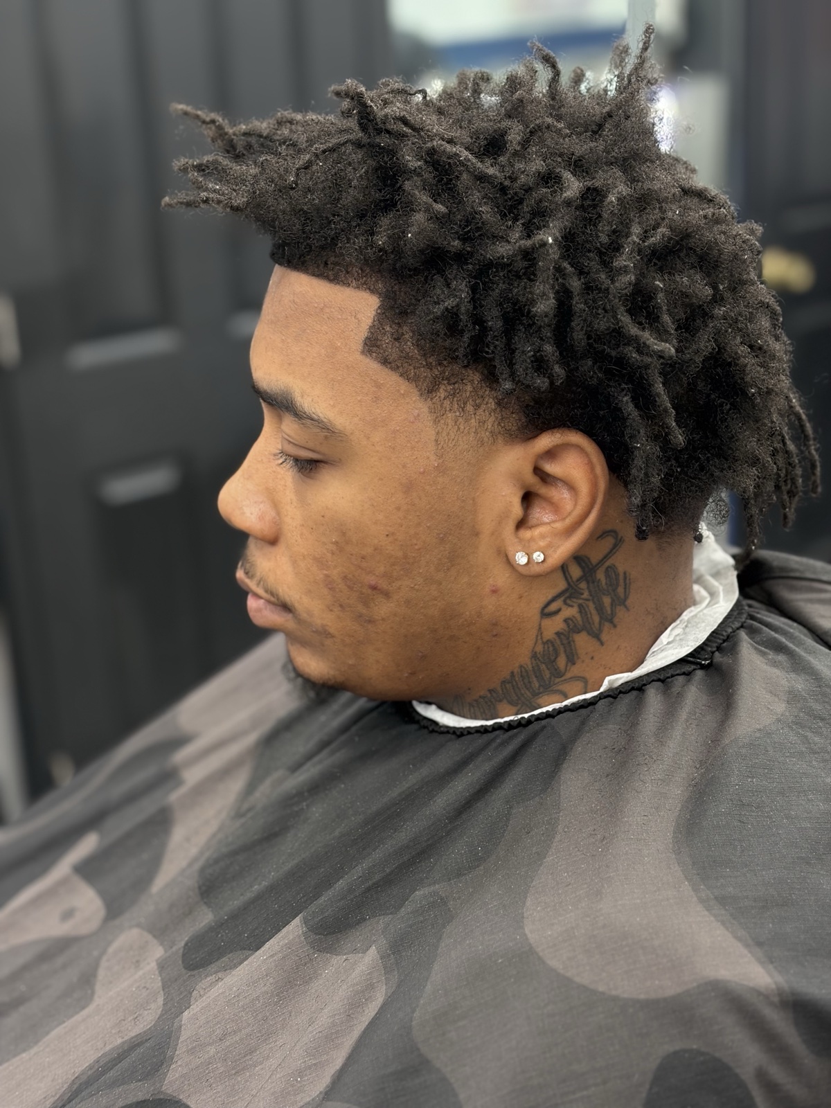 Eligio Roman — locs with low taper fade and sharp lineup
